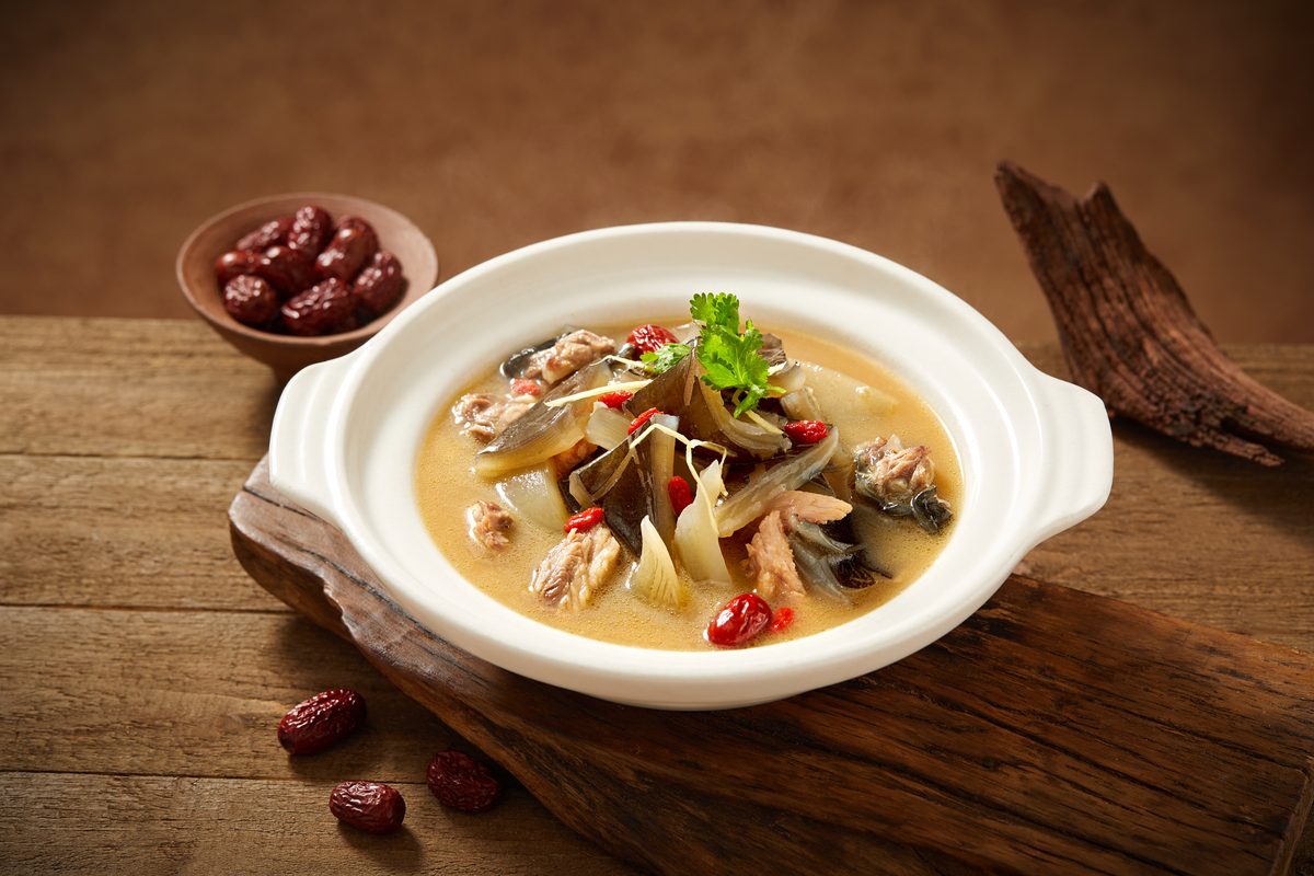Nourishing Claypot Turtle Soup, served in a white claypot with goji berries and red dates