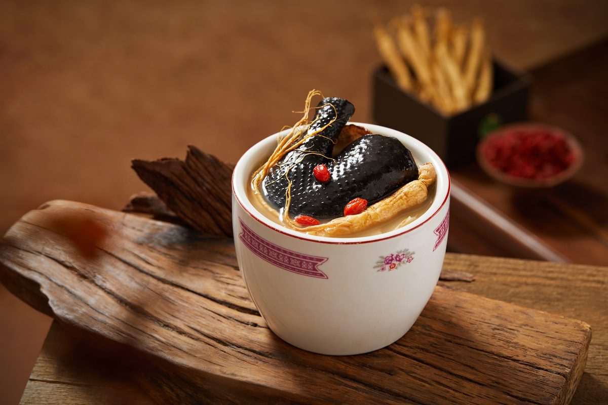 Ginseng Black Chicken Soup, black chicken with ginseng root in a double-boiling cup