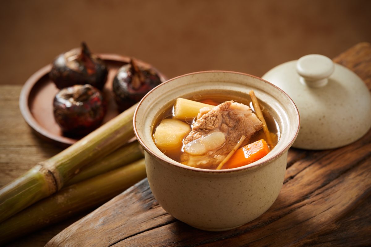 Sugarcane, Water Chestnut and Imperatae Root Soup, with sugarcane and water chestnuts beside the pot